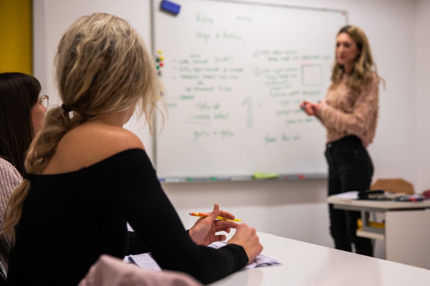 A trainer at the whiteboard with participants